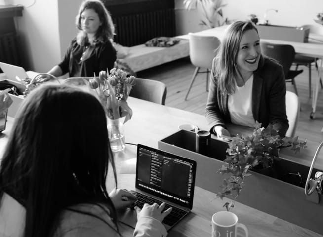 three women working at their desks